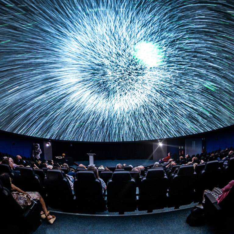 People watching stars on a Planetarium screen